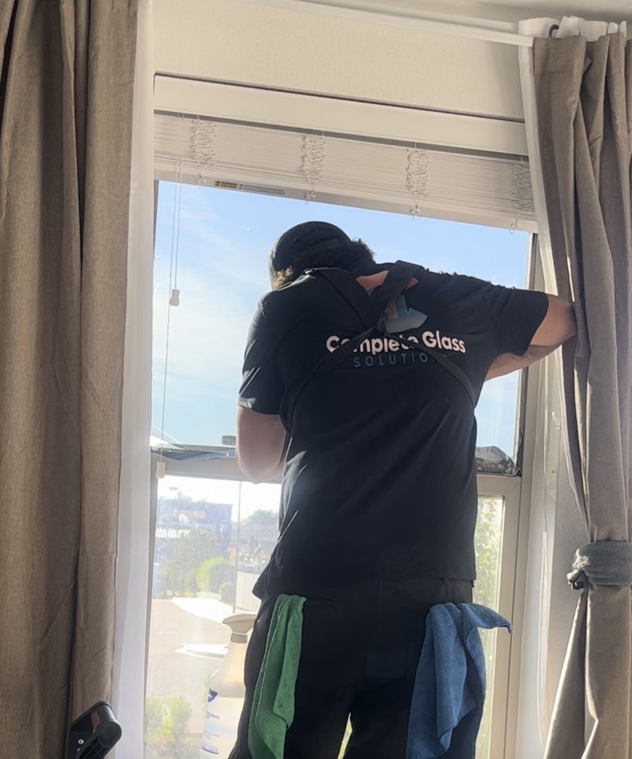 Technician installing window film on a residential window