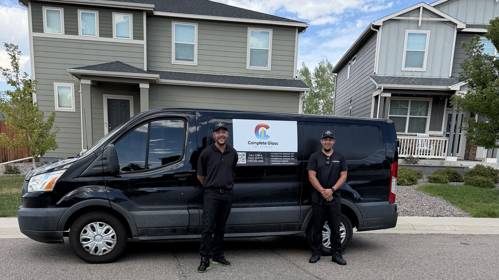 Complete Glass Solutions technicians standing in front of their branded service van on a Denver residential street